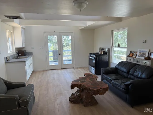 a kitchen with granite countertop white cabinets and a sink