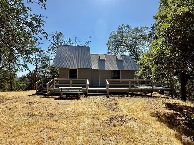 a view of house with outdoor space and sitting area
