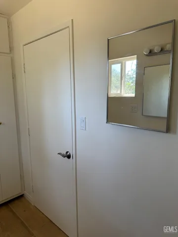a view of backyard with wooden fence and a bench