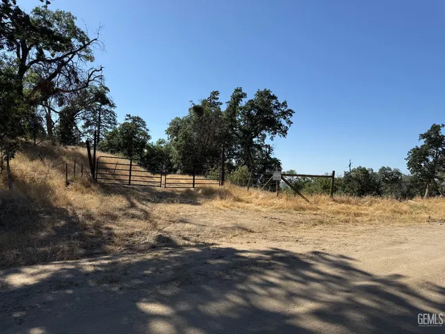 a view of a lake with a yard and large trees