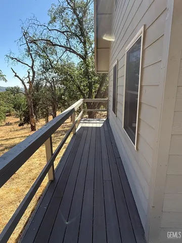 a view of balcony with wooden floor