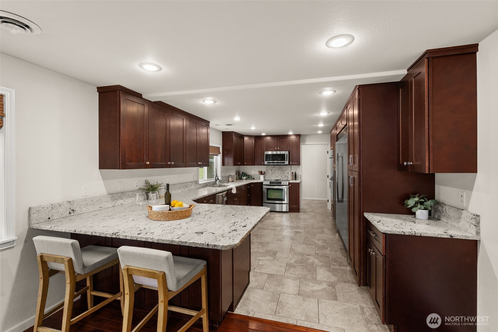 162 Southeast 16th Street Chehalis, WA 98532 - Photo 9 of 39 a kitchen with stainless steel appliances granite countertop a stove a refrigerator a sink a dining table and chairs