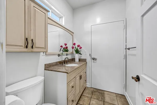 a bathroom with a sink toilet and mirror
