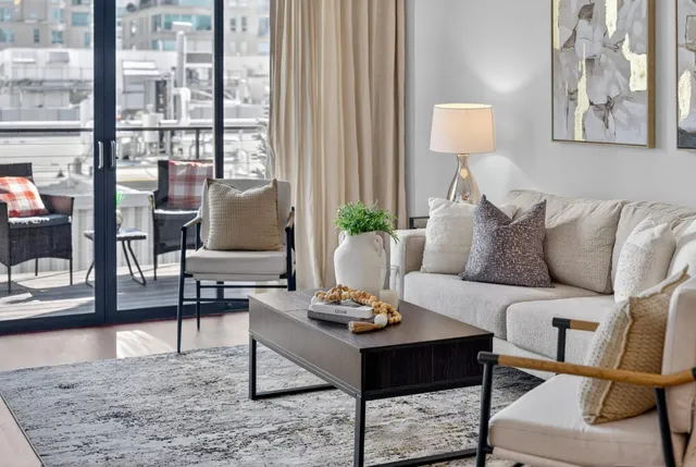 a kitchen with stainless steel appliances granite countertop a dining table chairs stove and refrigerator