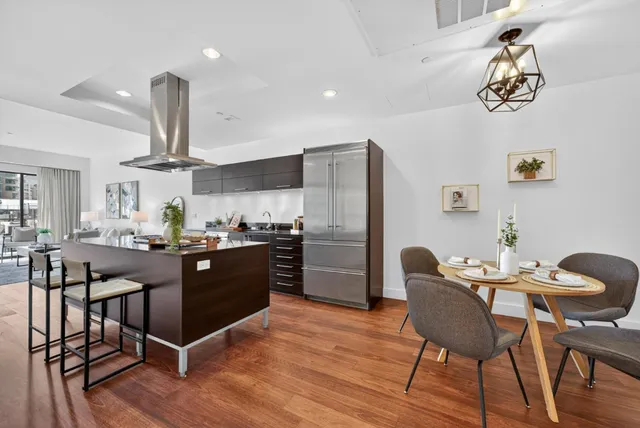 a view of a dining room with furniture wooden floor and a chandelier