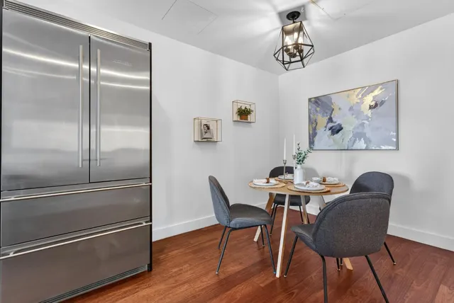 a kitchen with kitchen island a counter top space a sink stainless steel appliances and cabinets