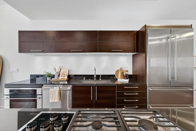 a kitchen with a refrigerator and a sink
