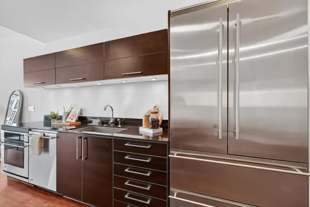 a kitchen with sink stove and cabinets