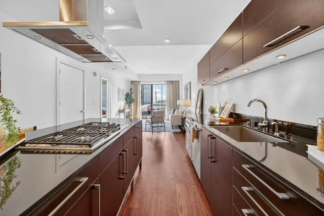 a kitchen with stainless steel appliances granite countertop a stove and cabinets