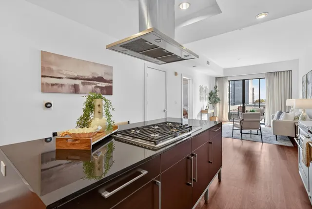 a kitchen with stainless steel appliances a stove a sink and a refrigerator