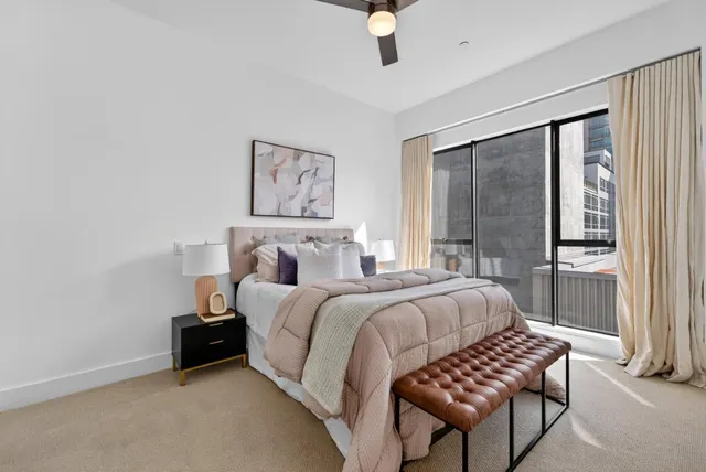 a bedroom with a bed and a painting on the wall