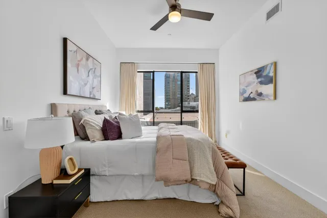 a view of a hallway with closet and wooden floor