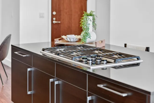 a living room with furniture and a painting on the wall