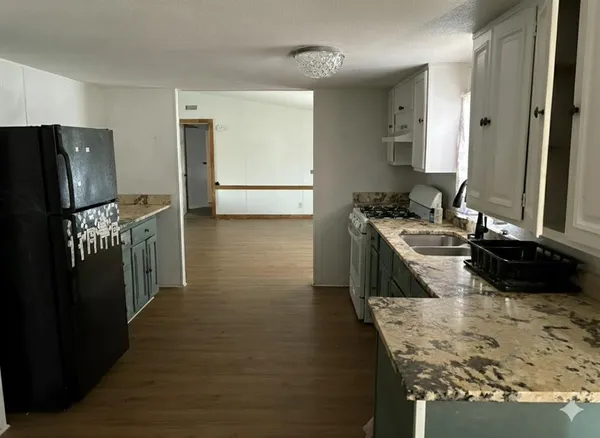 a kitchen with a sink stove and refrigerator