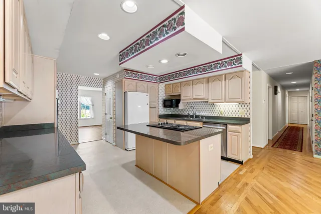 a kitchen with stainless steel appliances granite countertop a stove and a sink