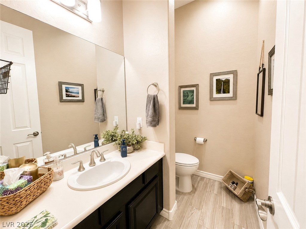 9724 University Ridge Avenue Las Vegas, NV 89149 - Photo 12 of 61 An inviting bathroom space featuring a wide mirror above the vanity and elegant tile flooring.