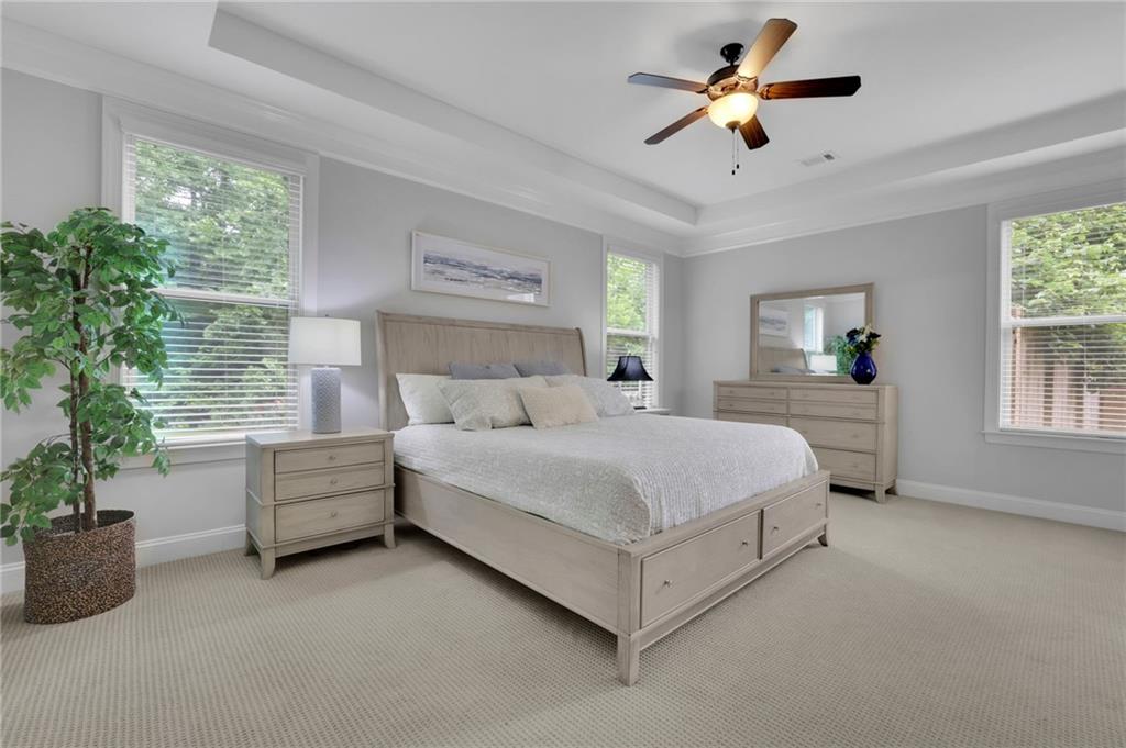 6255 Allison Road Cumming, GA 30040 - Photo 17 of 36 a bedroom with furniture and a chandelier fan