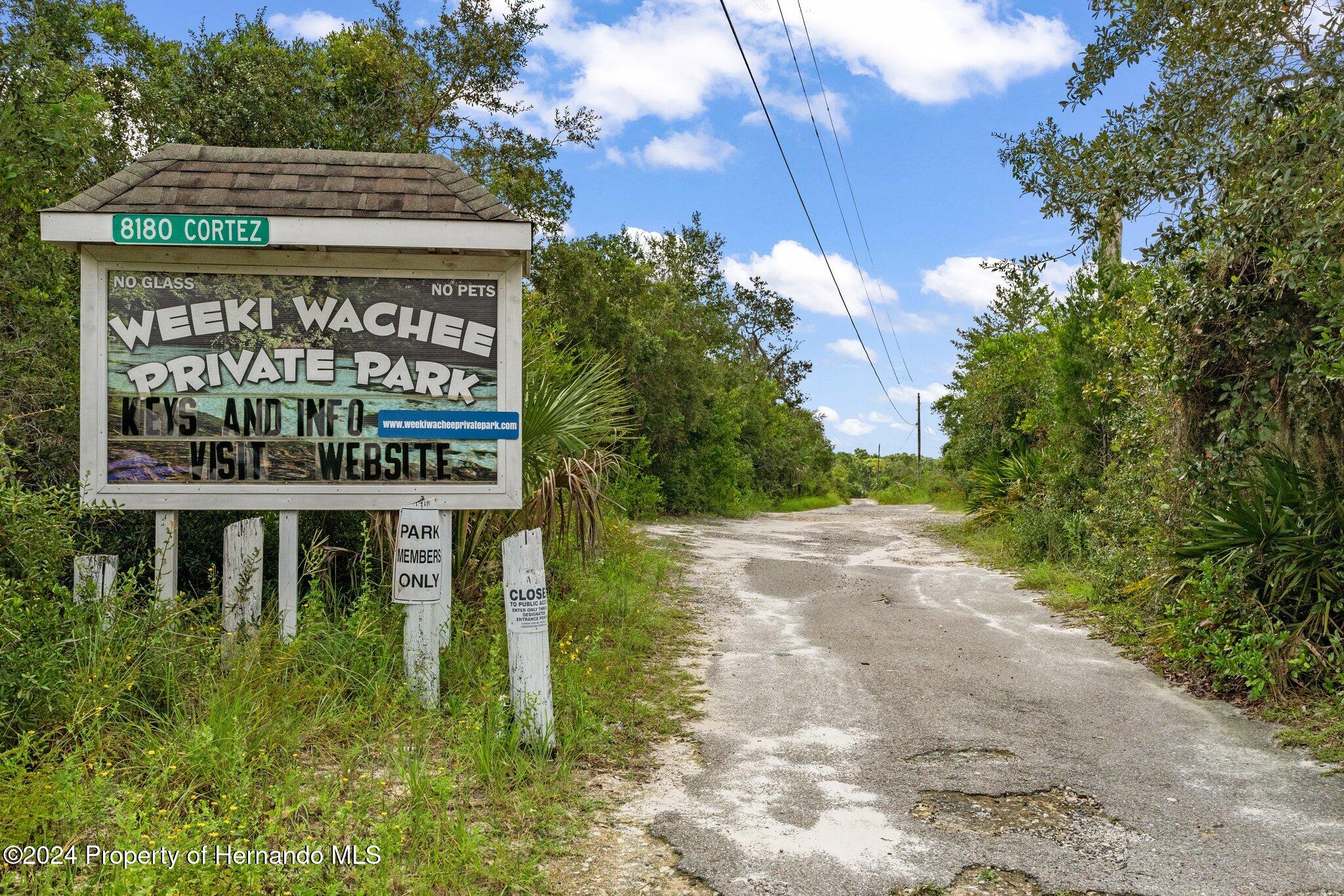 8055 Filson Street Weeki Wachee, FL 34613 - Photo 2 of 30 a sign on the side of a road
