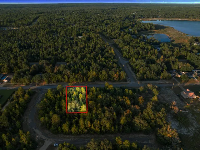 an aerial view of a house with a lake view