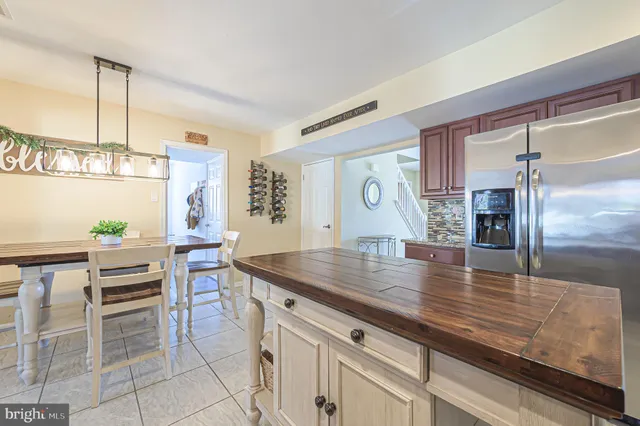 a view of a kitchen with kitchen island a counter top space appliances and cabinets
