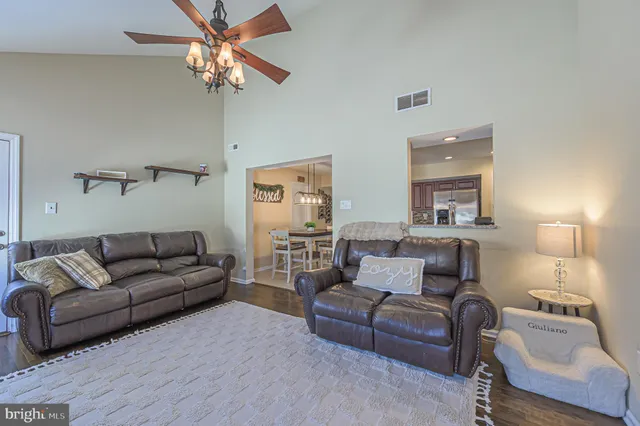 a living room with furniture and a lamp