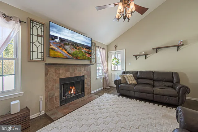 a living room with furniture a window and a fireplace