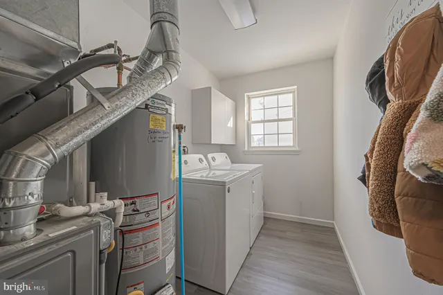 a room with cabinets a washer and dryer