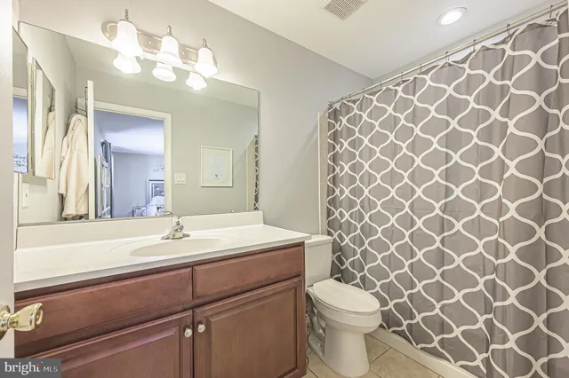 a bathroom with a sink mirror vanity and toilet