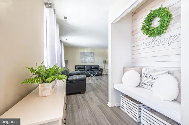 a living room with furniture and a potted plant