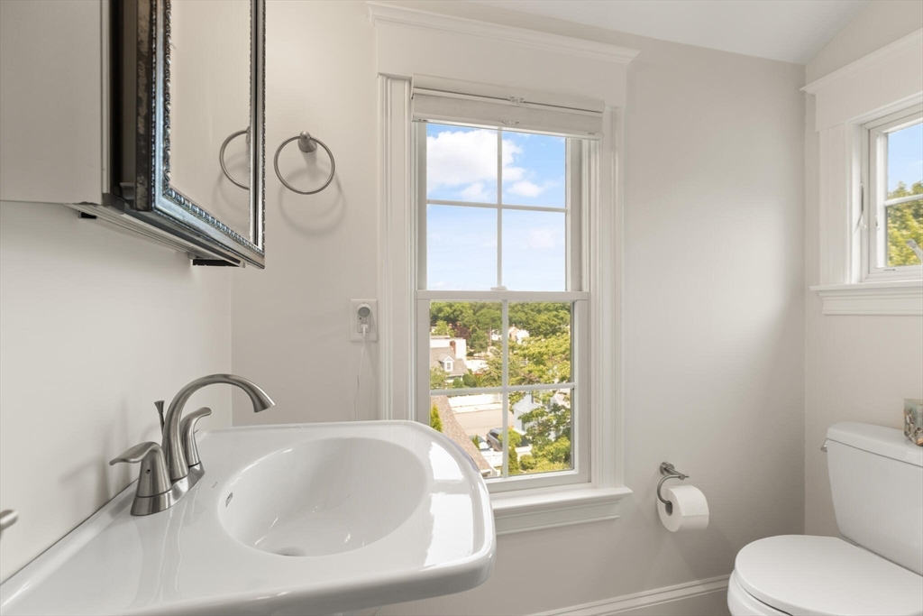 89 Dwinell Street Boston, MA 02132 - Photo 22 of 37 a bathroom with a sink a toilet and a window