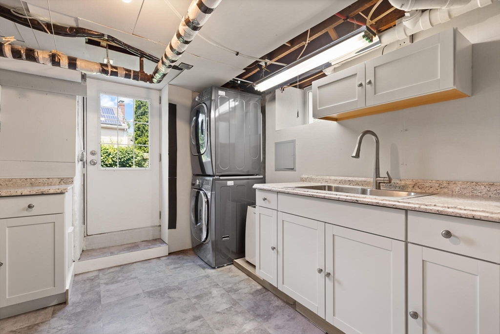 89 Dwinell Street Boston, MA 02132 - Photo 26 of 37 a kitchen with sink cabinets and refrigerator