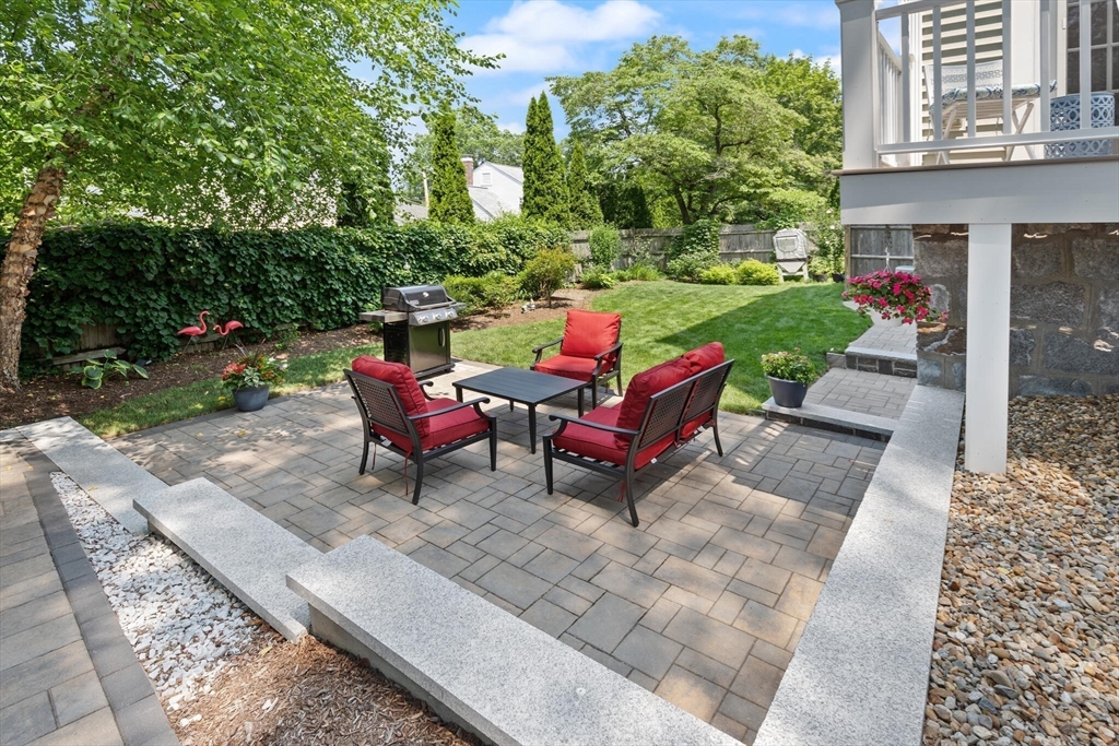 89 Dwinell Street Boston, MA 02132 - Photo 30 of 37 a view of a backyard with sitting area and garden