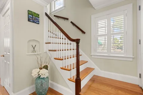 a view of entryway with wooden floor and a front door