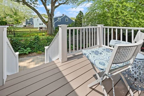 a view of balcony with wooden floor and outdoor seating