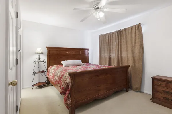 a bed sitting in a room next to a window