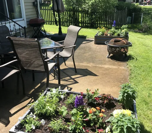 a backyard of a house with table and chairs