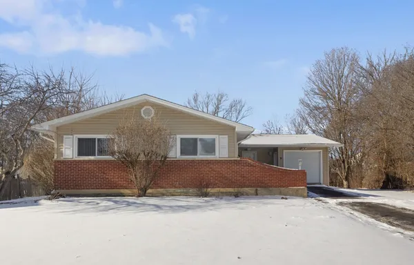 a front view of house with yard and trees