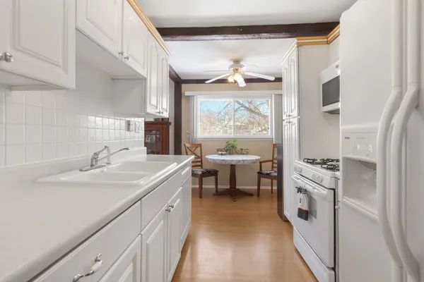 a kitchen with a sink stove and refrigerator