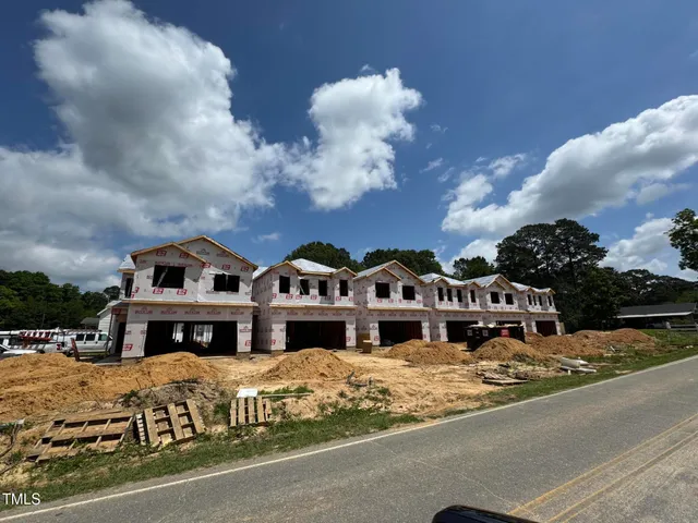 a front view of multiple houses with yard