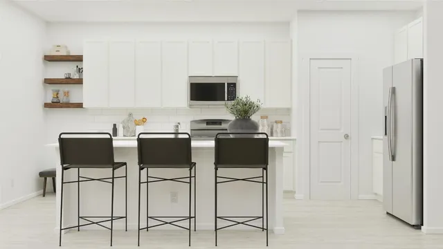 a kitchen with cabinets and chairs