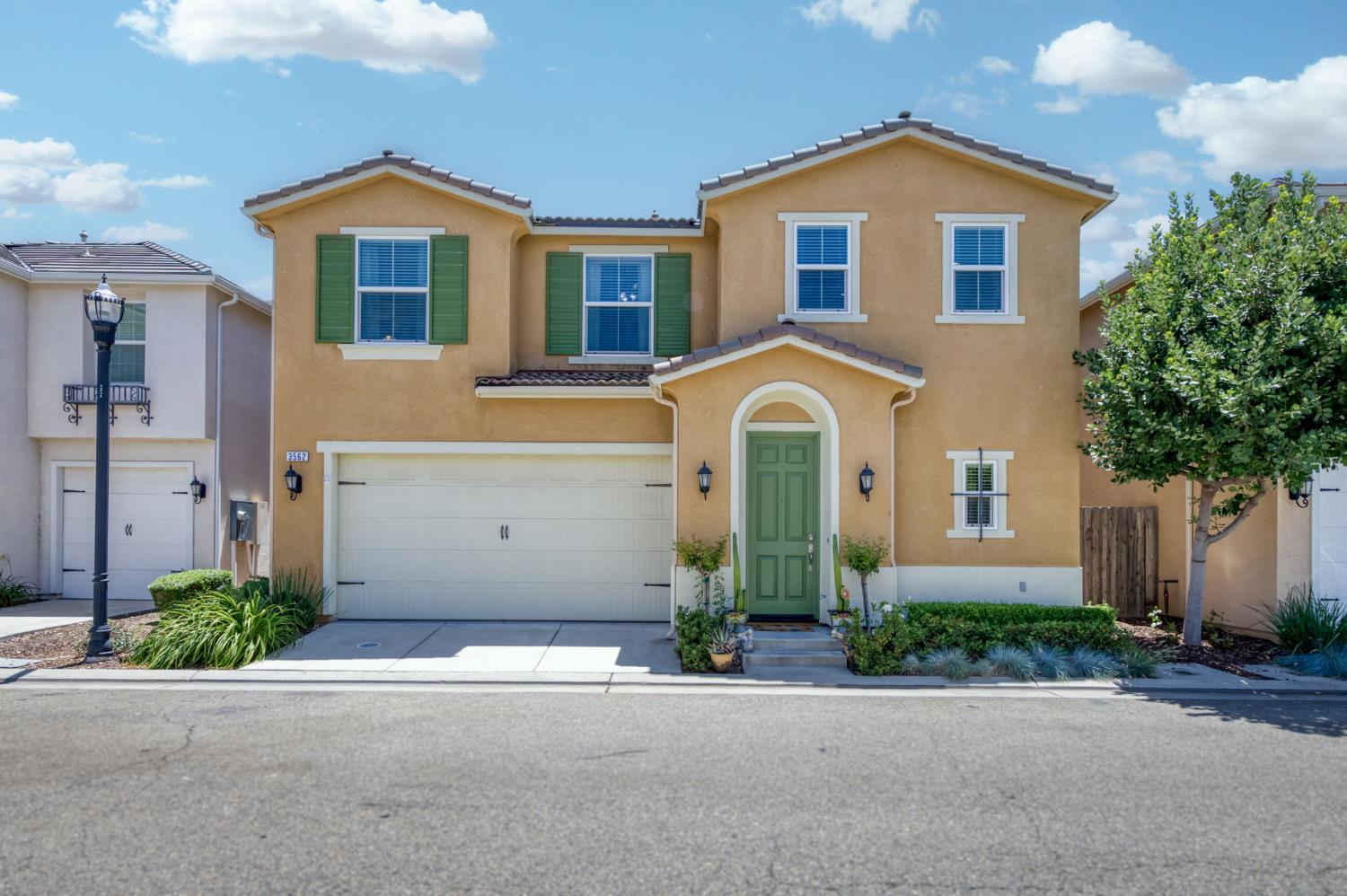 3562 Luminary Way Clovis, CA 93619 - Photo 1 of 40 a front view of a house with a yard and garage