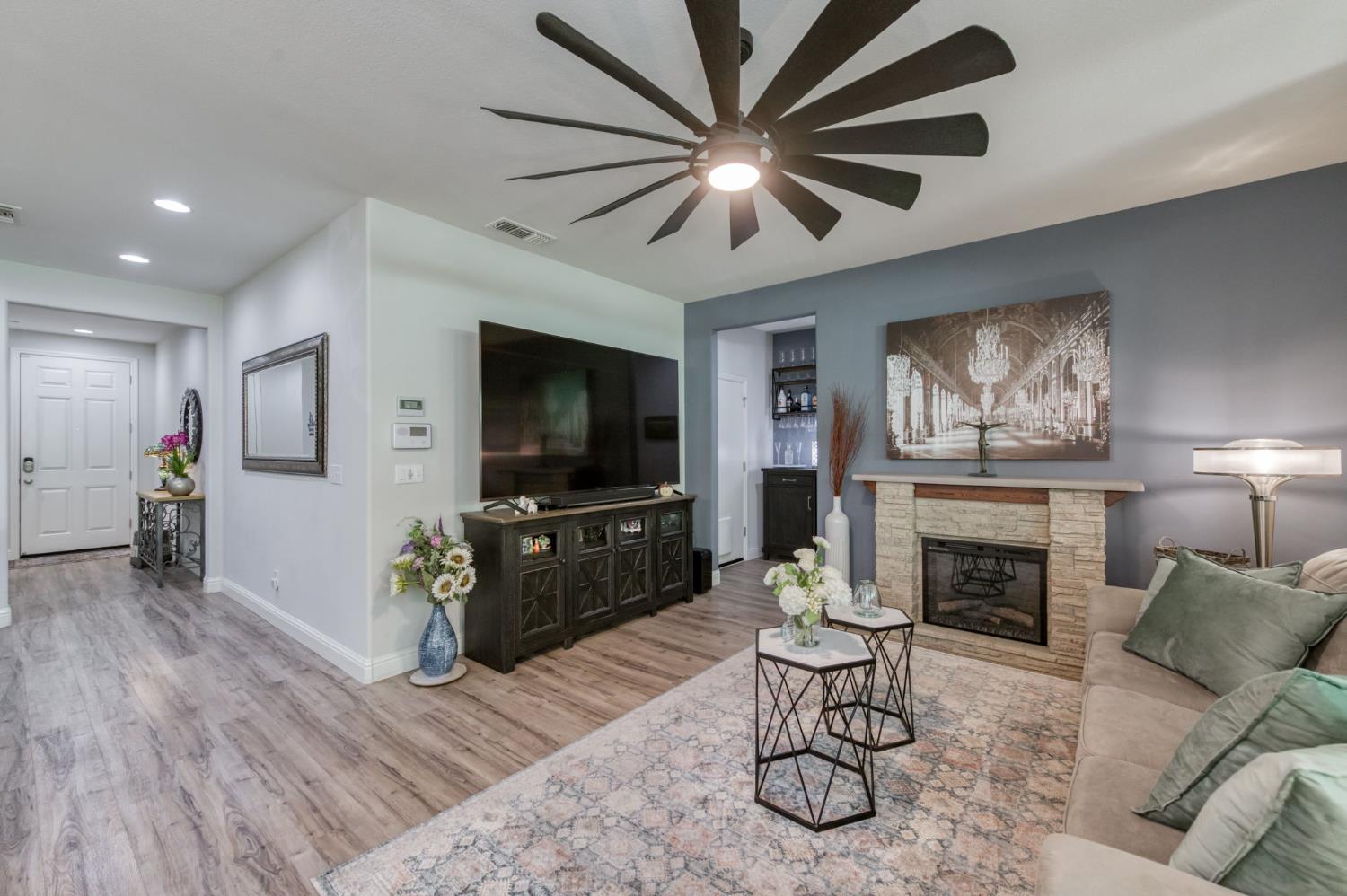 3562 Luminary Way Clovis, CA 93619 - Photo 11 of 40 a living room with furniture a flat screen tv and a fireplace