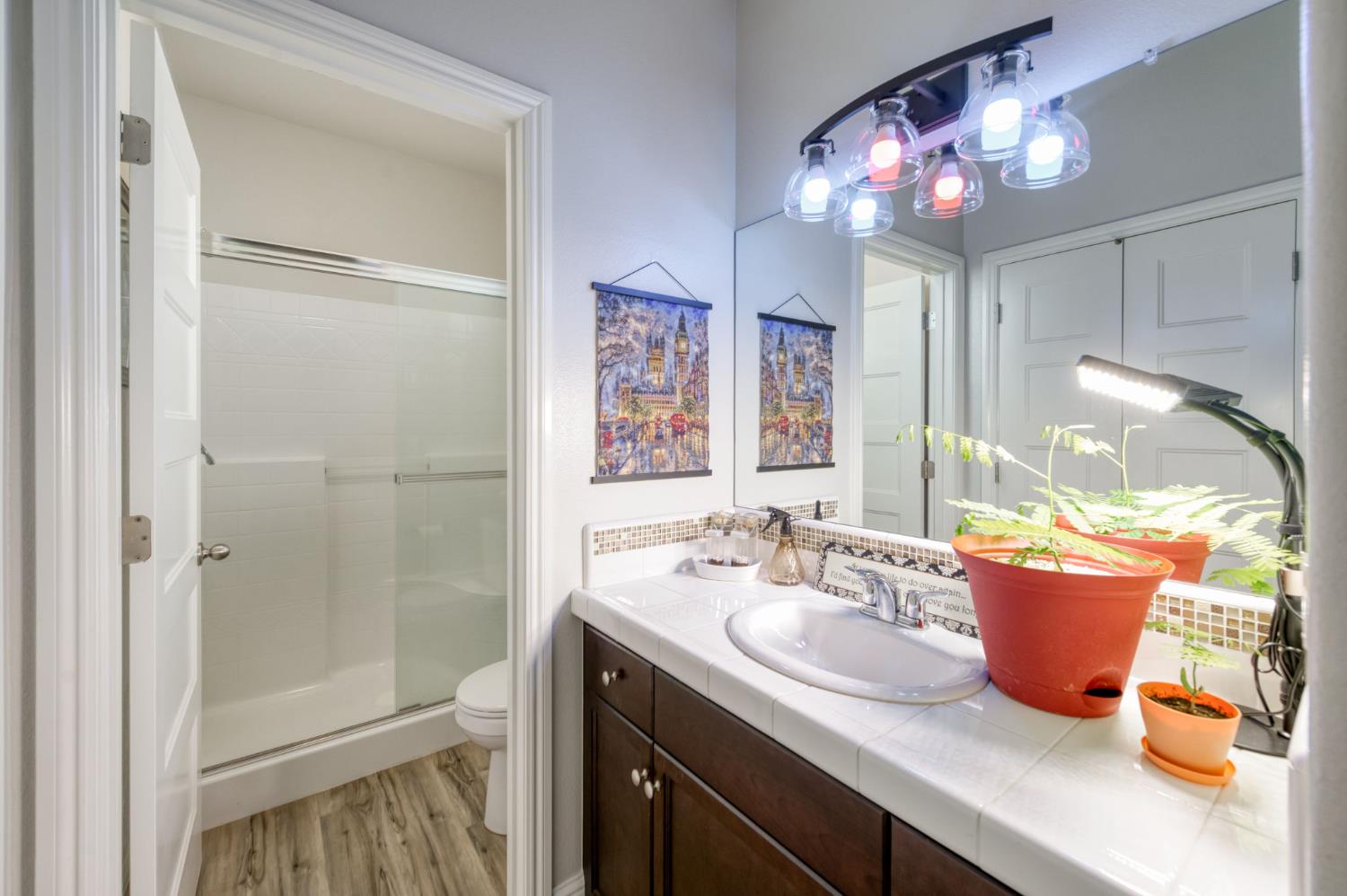 3562 Luminary Way Clovis, CA 93619 - Photo 17 of 40 a bathroom with a sink a light fixture and a mirror