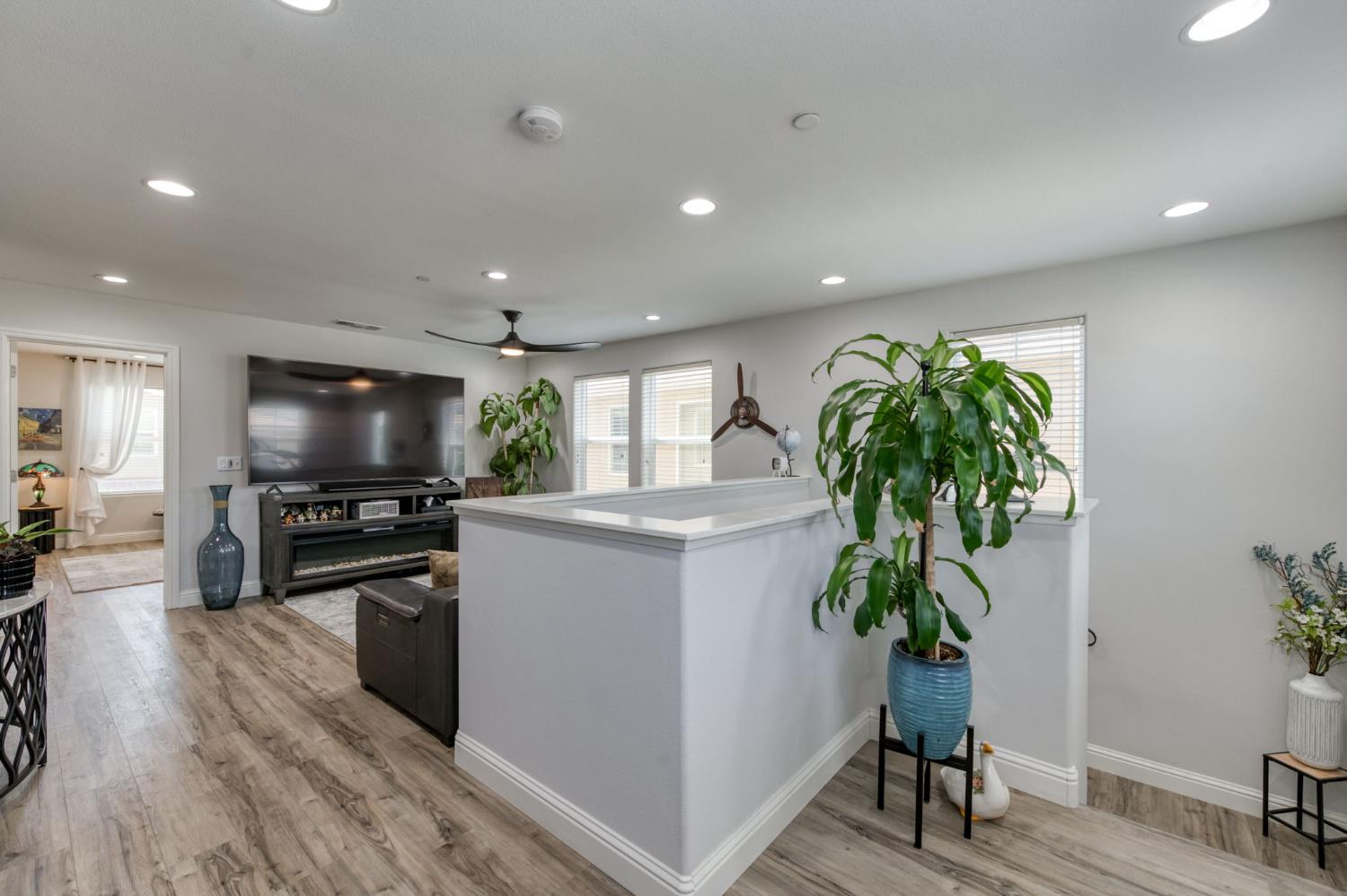 3562 Luminary Way Clovis, CA 93619 - Photo 19 of 40 a kitchen with stainless steel appliances a sink a stove top oven a counter space and wooden floor
