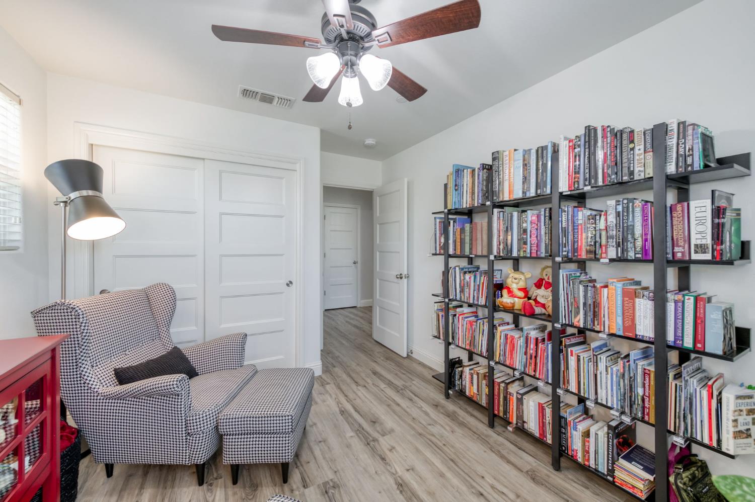 3562 Luminary Way Clovis, CA 93619 - Photo 26 of 40 a living room with lots of furniture and a book shelf