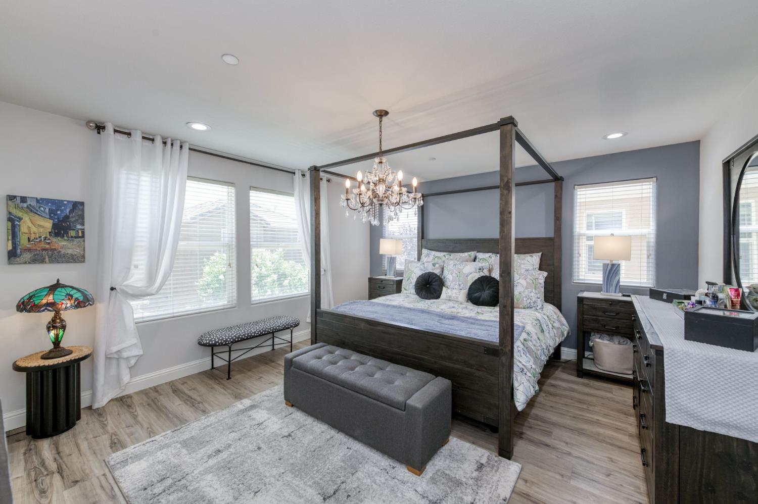 3562 Luminary Way Clovis, CA 93619 - Photo 29 of 40 a bedroom with a bed and a chandelier