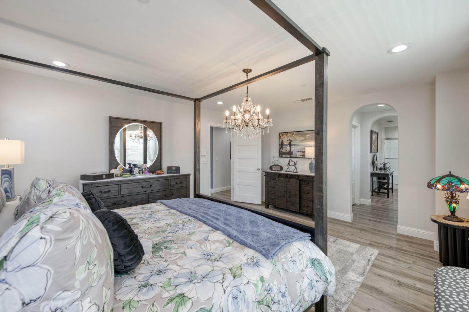 3562 Luminary Way Clovis, CA 93619 - Photo 30 of 40 a bedroom with a bed and a chandelier