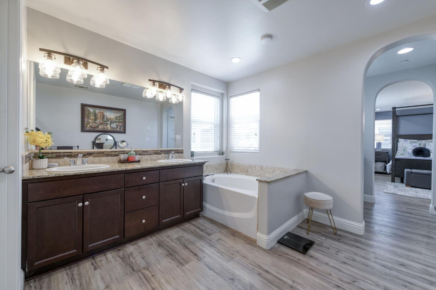 3562 Luminary Way Clovis, CA 93619 - Photo 33 of 40 a spacious bathroom with a double vanity sink a mirror and a toilet
