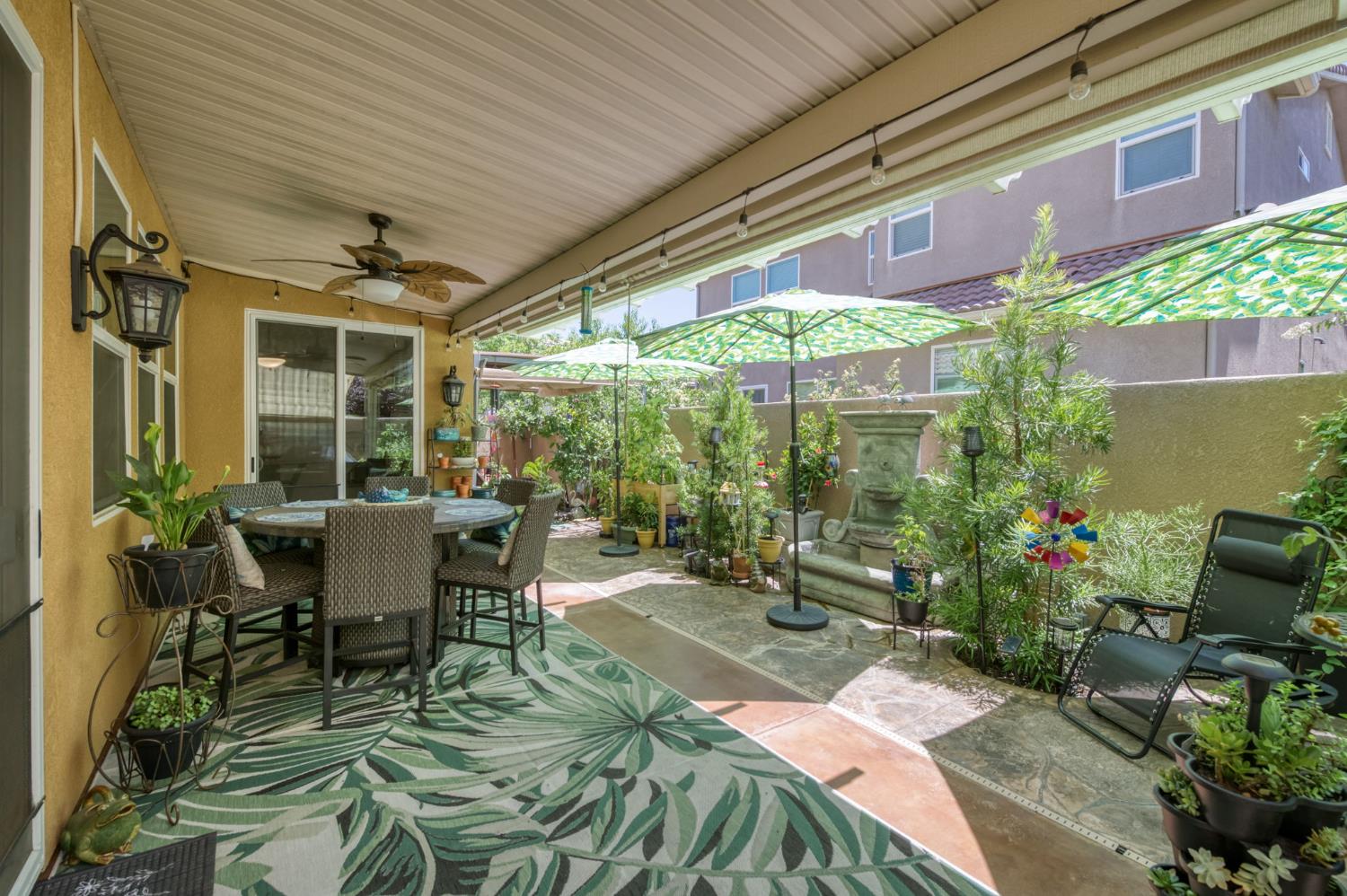 3562 Luminary Way Clovis, CA 93619 - Photo 34 of 40 a patio with table and chairs and potted plants