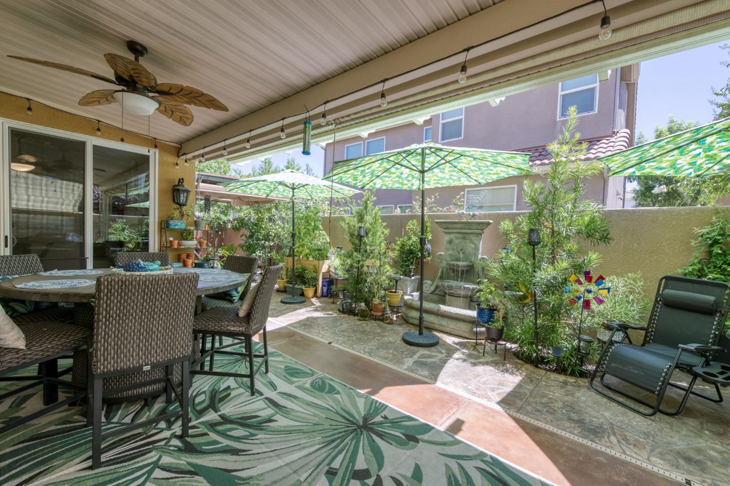 3562 Luminary Way Clovis, CA 93619 - Photo 37 of 40 a patio with table and chairs and potted plants